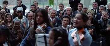Movie still from “Changing Lanes” (2002), directed by Roger Michell – A group of people in suits and ties clapping; Medium shot, Over the shoulder angle