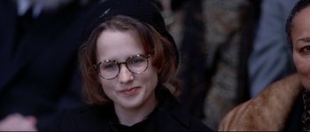 Movie still from “Changing Lanes” (2002), directed by Roger Michell – A woman wearing glasses and wearing a hat; Close Up shot, Over the shoulder angle