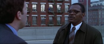 Movie still from “Changing Lanes” (2002), directed by Roger Michell – A man standing in front of a brick building; Close Up shot, Low angle