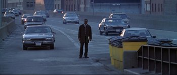 Movie still from “Changing Lanes” (2002), directed by Roger Michell – A man standing on the side of a road; Wide shot, High angle
