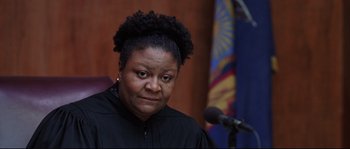 Movie still from “Changing Lanes” (2002), directed by Roger Michell – A woman in a black gown is looking at the camera; Close Up shot, Low angle