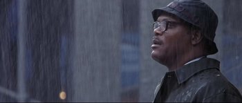 Movie still from “Changing Lanes” (2002), directed by Roger Michell – A man with glasses is standing in the rain; Close Up shot, Low angle