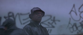 Movie still from “Changing Lanes” (2002), directed by Roger Michell – A man wearing a hat standing in front of a wall; Close Up shot, Low angle