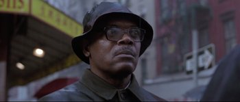 Movie still from “Changing Lanes” (2002), directed by Roger Michell – A person wearing glasses and a hat; Close Up shot, Low angle
