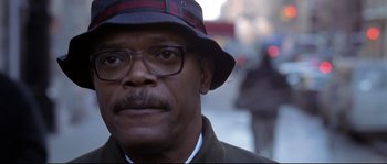 Movie still from “Changing Lanes” (2002), directed by Roger Michell – A person wearing glasses and a hat; Close Up shot, Low angle