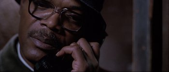 Movie still from “Changing Lanes” (2002), directed by Roger Michell – A person talking on a cell phone; Close Up shot, Low angle