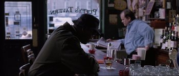 Movie still from “Changing Lanes” (2002), directed by Roger Michell – A man sitting at a table in front of two other men; Medium shot, Over the shoulder angle