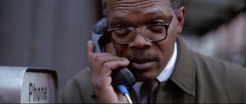 Movie still from “Changing Lanes” (2002), directed by Roger Michell – An older man talking on a phone while wearing glasses; Close Up shot, Low angle