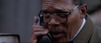 Movie still from “Changing Lanes” (2002), directed by Roger Michell – An older man wearing glasses talking on a cell phone; Close Up shot, High angle