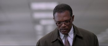 Movie still from “Changing Lanes” (2002), directed by Roger Michell – A man in a brown jacket and a tie; Close Up shot, Low angle