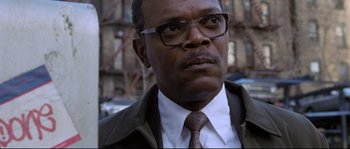 Movie still from “Changing Lanes” (2002), directed by Roger Michell – A person wearing glasses and a tie; Close Up shot, Low angle