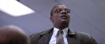 Movie still from “Changing Lanes” (2002), directed by Roger Michell – A man in a suit and tie looking upward; Close Up shot, Low angle