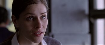 Movie still from “Changing Lanes” (2002), directed by Roger Michell – A woman's face in a dark room; Close Up shot, Over the shoulder angle