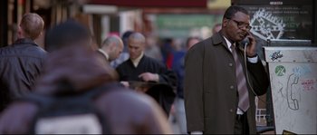 Movie still from “Changing Lanes” (2002), directed by Roger Michell – A group of people walking down a street; Medium shot, Over the shoulder angle