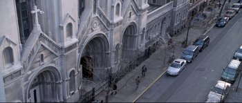 Movie still from “Changing Lanes” (2002), directed by Roger Michell – An aerial view of a building with a lot of people walking on the sidewalk; Extreme Wide shot, High angle