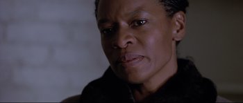 Movie still from “Changing Lanes” (2002), directed by Roger Michell – A person with short black hair; Close Up shot, Low angle