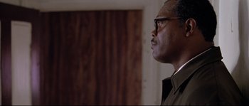 Movie still from “Changing Lanes” (2002), directed by Roger Michell – An older man wearing glasses looking up into the sky; Close Up shot, Low angle