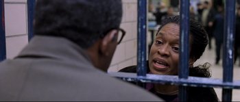 Movie still from “Changing Lanes” (2002), directed by Roger Michell – An older woman looking in the mirror at an older man; Close Up shot, Over the shoulder angle