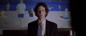 Movie still from “Changing Lanes” (2002), directed by Roger Michell – A man with curly hair wearing a suit and tie; Close Up shot, Low angle