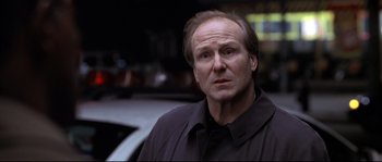 Movie still from “Changing Lanes” (2002), directed by Roger Michell – A person wearing a black shirt; Close Up shot, Low angle