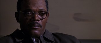 Movie still from “Changing Lanes” (2002), directed by Roger Michell – A person wearing glasses and a suit; Close Up shot, High angle