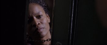 Movie still from “Changing Lanes” (2002), directed by Roger Michell – A person wearing a chain around their neck; Close Up shot, Low angle