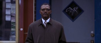 Movie still from “Changing Lanes” (2002), directed by Roger Michell – A man in a brown coat and a white tie; Close Up shot, Low angle