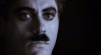 Movie still from “Chaplin” (1992), directed by Richard Attenborough – A man's face with a mustache; Extreme Close Up shot, Low angle