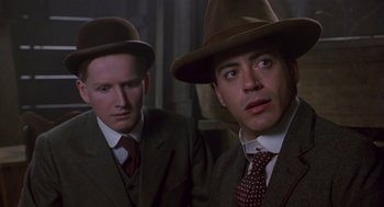 Movie still from “Chaplin” (1992), directed by Richard Attenborough – A couple of men wearing suits and hats; Close Up shot, Low angle