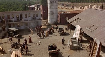 Movie still from “Chaplin” (1992), directed by Richard Attenborough – An aerial view of people walking around a town; Extreme Wide shot, High angle