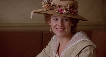 Movie still from “Chaplin” (1992), directed by Richard Attenborough – A woman wearing a hat with flowers on top of her head; Close Up shot, Low angle