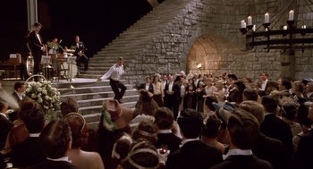 Movie still from “Chaplin” (1992), directed by Richard Attenborough – A crowd of people standing on steps in front of a building; Wide shot, High angle