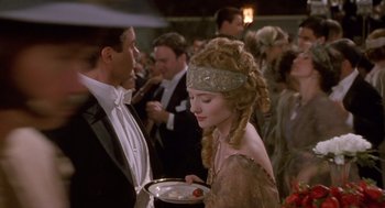 Movie still from “Chaplin” (1992), directed by Richard Attenborough – A man and a woman dressed in formal wear; Medium shot, Over the shoulder angle