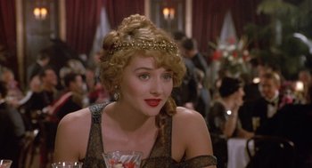Movie still from “Chaplin” (1992), directed by Richard Attenborough – A person wearing a tiara; Close Up shot, Over the shoulder angle
