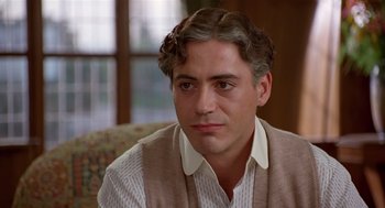 Movie still from “Chaplin” (1992), directed by Richard Attenborough – A person sitting on a couch; Close Up shot, Over the shoulder angle