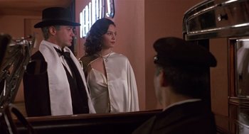 Movie still from “Chaplin” (1992), directed by Richard Attenborough – A man and a woman standing in front of a mirror; Medium shot, Low angle