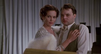 Movie still from “Chaplin” (1992), directed by Richard Attenborough – A man and a woman posing for a picture; Medium shot, Low angle