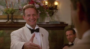 Movie still from “Chaplin” (1992), directed by Richard Attenborough – A man in a white suit and a black bow tie; Close Up shot, Low angle