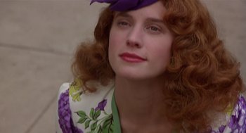 Movie still from “Chaplin” (1992), directed by Richard Attenborough – A person with curly hair wearing a purple hat; Close Up shot, Low angle