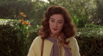 Movie still from “Chaplin” (1992), directed by Richard Attenborough – A young woman with long brown hair wearing a yellow sweater; Close Up shot, Over the shoulder angle