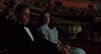 Movie still from “Chaplin” (1992), directed by Richard Attenborough – A man and a woman sitting in a theater; Medium shot, Low angle