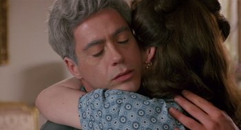 Movie still from “Chaplin” (1992), directed by Richard Attenborough – A man and a woman embracing each other; Close Up shot, Over the shoulder angle