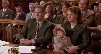 Movie still from “Chaplin” (1992), directed by Richard Attenborough – A group of people sitting in front of a crowd; Medium shot, High angle