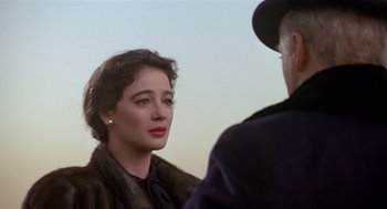 Movie still from “Chaplin” (1992), directed by Richard Attenborough – A man and a woman standing next to each other; Close Up shot, Over the shoulder angle