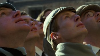 Movie still from “Chariots of Fire” (1981), directed by Hugh Hudson – A group of young men standing next to each other; Close Up shot, Low angle