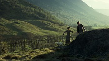 Movie still from “Chariots of Fire” (1981), directed by Hugh Hudson – A man and a woman walking a dog up a hill; Extreme Wide shot, High angle