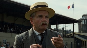 Movie still from “Chariots of Fire” (1981), directed by Hugh Hudson – An older man wearing a straw hat and a suit; Close Up shot, Low angle