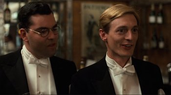 Movie still from “Chariots of Fire” (1981), directed by Hugh Hudson – Two men in tuxedos standing next to each other; Close Up shot, Low angle