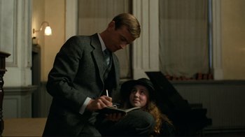 Movie still from “Chariots of Fire” (1981), directed by Hugh Hudson – A man and a woman in a suit and hat; Medium shot, Over the shoulder angle