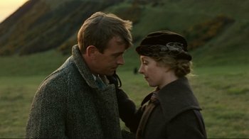 Movie still from “Chariots of Fire” (1981), directed by Hugh Hudson – A man and a woman standing next to each other in a field; Close Up shot, Low angle